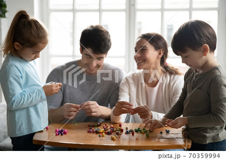 Happy parents engaged in creative activity with kids 70359994