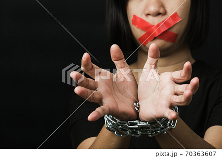 Asian woman blindfold wrapping mouth with red adhesive tape and she was hand tethered Asian woman blindfold wrapping mouth with red adhesive tape and she was hand tethered 70363607