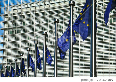 EU Flags in the wind in front of the Berlaymont building in Brussels EU Flags in the wind in front of the Berlaymont building in Brussels 70367305