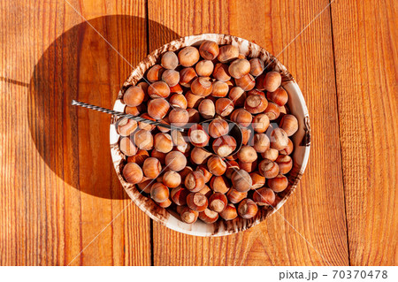 New crop hazelnuts in ceramic bowl with nut crusher on the wooden