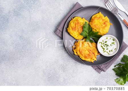 Fried cakes of grated potatoes on the plate with sauce. Traditional pancakes boxty raggmunk. Fried cakes of grated potatoes on the plate with sauce. Traditional pancakes boxty raggmunk. 70370885