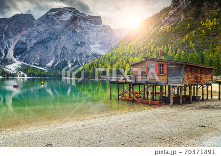 Wooden boathouse and boats on the alpine lake, Dolomites, Italy 70371891