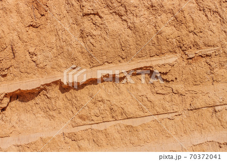 Background of great clay wall or brown ocher. Grunge rock texture Cracked ground texture in vintage style. Canyon rock. Background of great clay wall or brown ocher. Grunge rock texture Cracked ground texture in vintage style. Canyon rock. 70372041