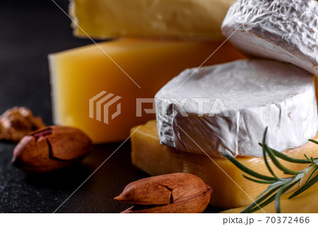 Beautiful delicious camembert cheese, parmesan, brie with grapes and figs 70372466