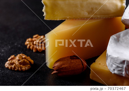 Beautiful delicious camembert cheese, parmesan, brie with grapes and figs Beautiful delicious camembert cheese, parmesan, brie with grapes and figs 70372467