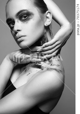 Beautiful Young woman with Dirty Paint Face 70375174