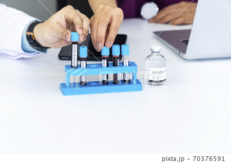 Two hand of doctor wear uniform clothes with stethoscope while holding test tube Two hand of doctor wear uniform clothes with stethoscope while holding test tube 70376591
