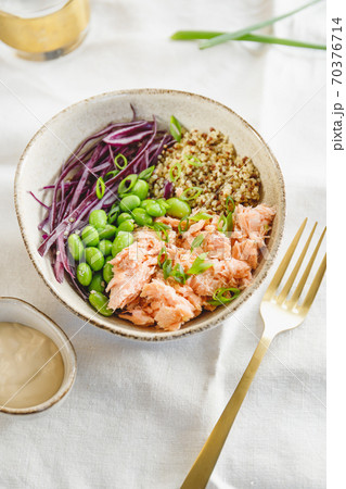 Poke bowl with couscous, baked salmon, bean, and cabbage. Healthy eating concept. Poke bowl with couscous, baked salmon, bean, and cabbage. Healthy eating concept. 70376714