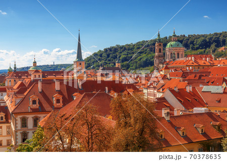Red rooftops of old Lesser Town (Lesser Quarter) of Prague under blue summer sky. With clock tower and dome of St. Nicholas Cathedral, tower of St Thomas church and church of St Josef Red rooftops of old Lesser Town (Lesser Quarter) of Prague under blue summer sky. With clock tower and dome of St. Nicholas Cathedral, tower of St Thomas church and church of St Josef 70378635