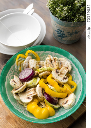 A bowl of marinated vegetables prepped for outdoor grilling. Dinner party for friends. A bowl of marinated vegetables prepped for outdoor grilling. Dinner party for friends. 70379082