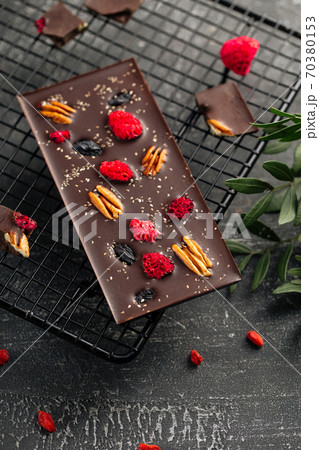 Handmade chocolate bar with pecan and dried berry 70380153