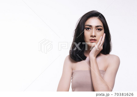 Charming young woman touching her face with clean fresh skin. Charming young woman touching her face with clean fresh skin. 70381626