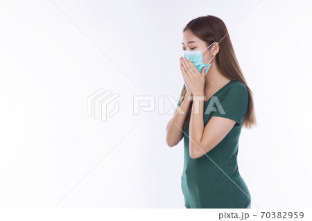 Student young woman wearing safety medical mask protection from inhaling airborne bacteria Student young woman wearing safety medical mask protection from inhaling airborne bacteria 70382959
