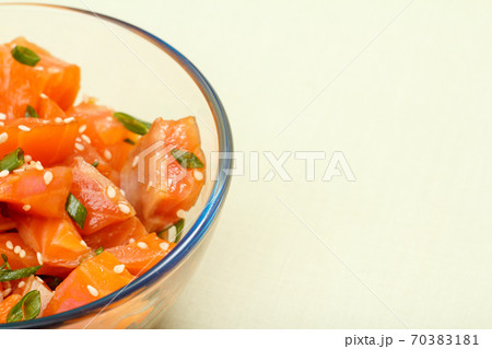 Hawaiian salmon poke with green onions and sesame seeds Hawaiian salmon poke with green onions and sesame seeds 70383181