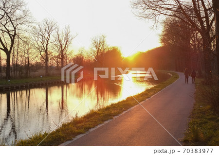 Panorama of a gorgeous scenic sunset at a river or canal Panorama of a gorgeous scenic sunset at a river or canal 70383977