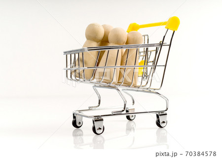 Wooden stick figure in a trolley on a white background. 70384578