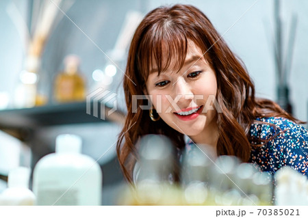 ショッピング中商品を吟味する若い女性のアップ 70385021