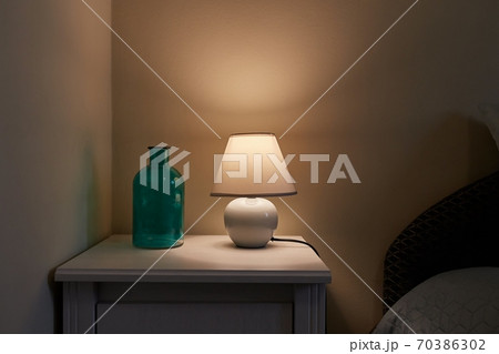 Lamp on a nightstand Lamp on a nightstand 70386302