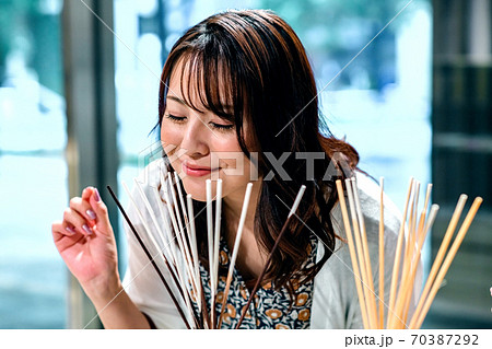 インテリア雑貨店で芳香剤の香りを楽しむショッピング中の女性 70387292