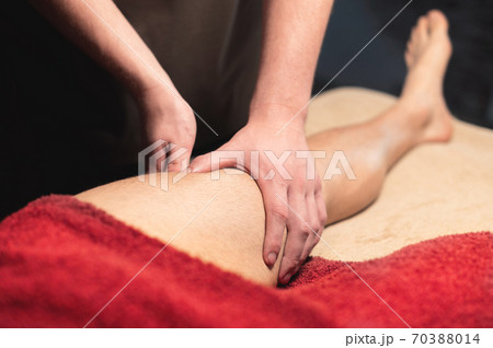 Close-up of professional knee and hip massage. Male masseur doing massage to male client 70388014
