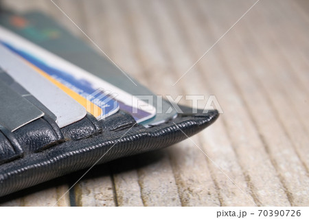 close up of credit cards in a wallet on wooden background  70390726