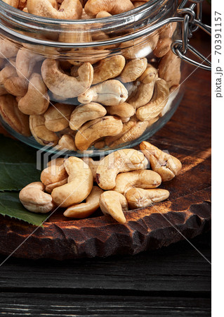 Bowl with cashew nuts on wooden table. Delicacies Bowl with cashew nuts on wooden table. Delicacies 70391157