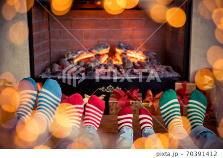 Happy family with children near fireplace at Christmas 70391412