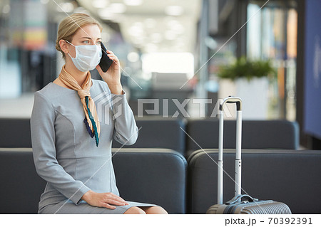Elegant Woman Wearing Mask in Waiting Lounge Elegant Woman Wearing Mask in Waiting Lounge 70392391