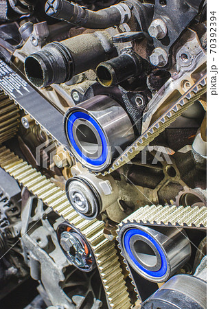 Car mechanic replacing timing belt 70392394