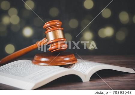 Old wood Judge hammer with law book on the table wood background, Used for adjudication and Justice. Old wood Judge hammer with law book on the table wood background, Used for adjudication and Justice. 70393048