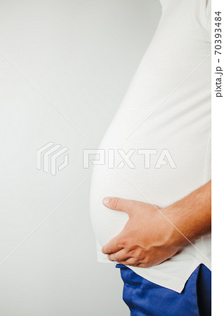 Overweight man holding big belly, copy space Overweight man holding big belly, copy space 70393484