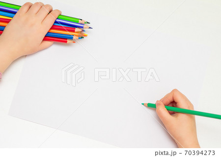 Child is drawing by colored pencils. 70394273