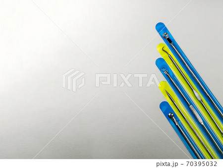 set of cosmetic tools for manual face cleansing on a gray background. Stainless steel. Problem skin. copy space set of cosmetic tools for manual face cleansing on a gray background. Stainless steel. Problem skin. copy space 70395032