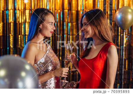 Two girls toasting celebrating New Year or Christmas 70395893