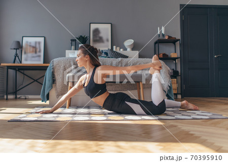 Athletic woman at home doing exercises, working out 70395910