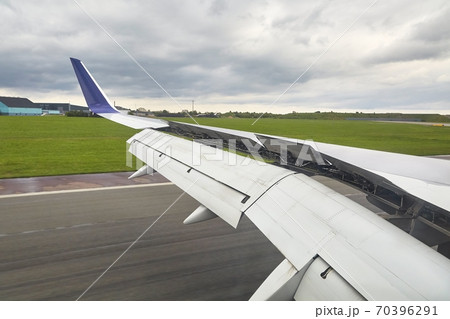 Landing plane wing flaps and spoilers extended 70396291
