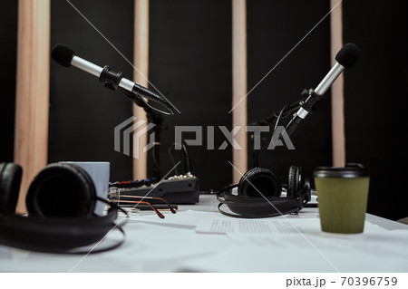 Working place of radio host. Close up of microphones, headphones and sound mixing desk on the table in recording studio or broadcast room 70396759