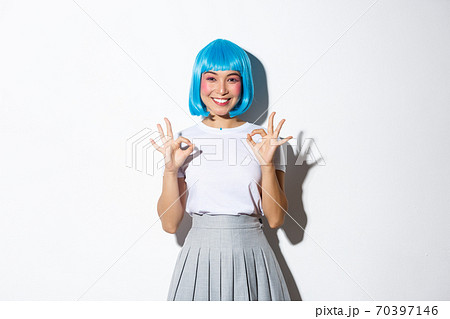 Image of satisfied beautiful asian girl in blue wig showing okay gesture in approval, like something, standing over white background in halloween costume 70397146