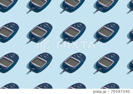 Glucose meter and pen on blue background with shadow, Metabolic syndrome concept 70397340