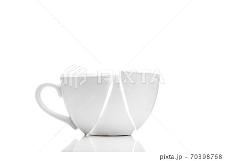 white ceramic cup broken into fragments as a result of the fall, a concept of a kitchen object on the theme of crisis on a white background with copy space. white ceramic cup broken into fragments as a result of the fall, a concept of a kitchen object on the theme of crisis on a white background with copy space. 70398768