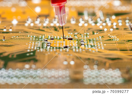 modern technologies of treatment and vaccination medicine research, silicone circuit board with a syringe with a needle filled with a red drug close-up. modern technologies of treatment and vaccination medicine research, silicone circuit board with a syringe with a needle filled with a red drug close-up. 70399277