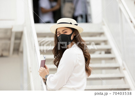 New normal of Asian young woman wearing protective mask holding passport ready to trevel at airplane,Traveling and Business during COVID-19 virus pandemic concept New normal of Asian young woman wearing protective mask holding passport ready to trevel at airplane,Traveling and Business during COVID-19 virus pandemic concept 70403538