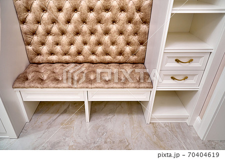 Classic white wardrobe with seating and shelves in contemporary bright hallway. Carriage coupler closet bench 70404619