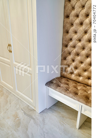 Classic white wardrobe with seating in contemporary bright hallway. Carriage coupler closet bench Classic white wardrobe with seating in contemporary bright hallway. Carriage coupler closet bench 70404772