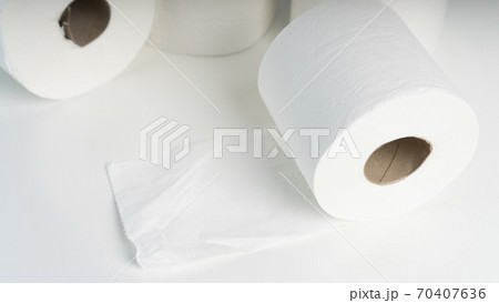 A pile of toilet paper rolls on a white table on a background of blue wall texture. A pile of toilet paper rolls on a white table on a background of blue wall texture. 70407636