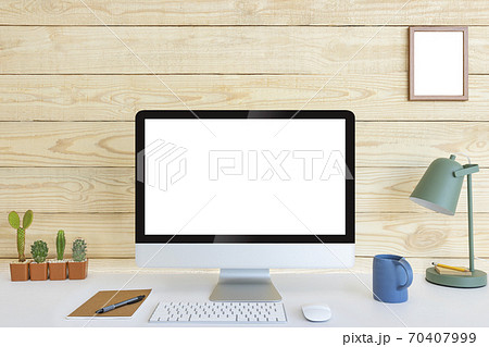 Computer with blank white copy space for text and wood background, Mockup design desktop computer in office on white table with keyboard and Coffee cub, Work place concept, Cactus in pot. 70407999