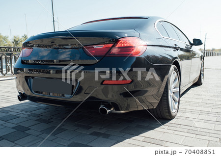 The rear of a luxury car in black The rear of a luxury car in black 70408851