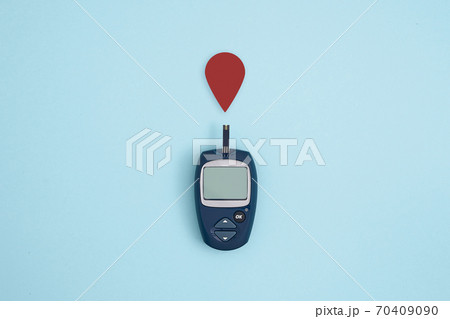 Glucose meter and blood drop on blue background, Metabolic syndrome concept 70409090
