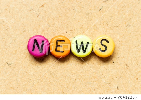 Round color bead with black letter in word news on wood background Round color bead with black letter in word news on wood background 70412257