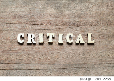 Alphabet letter block in word critical on wood background 70412259
